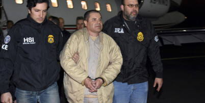 FILE - In this Jan. 19, 2017 file photo provided by U.S. law enforcement, authorities escort Joaquin "El Chapo" Guzman, center, from a plane to a waiting caravan of SUVs at Long Island MacArthur Airport, in Ronkonkoma, N.Y. Guzman's trial is set to begin Monday, Nov. 5, 2018, with jury selection. Opening statements are expected on Nov. 13. (U.S. law enforcement via AP, File)